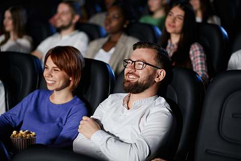 A group of people watching a movie in a cinema.